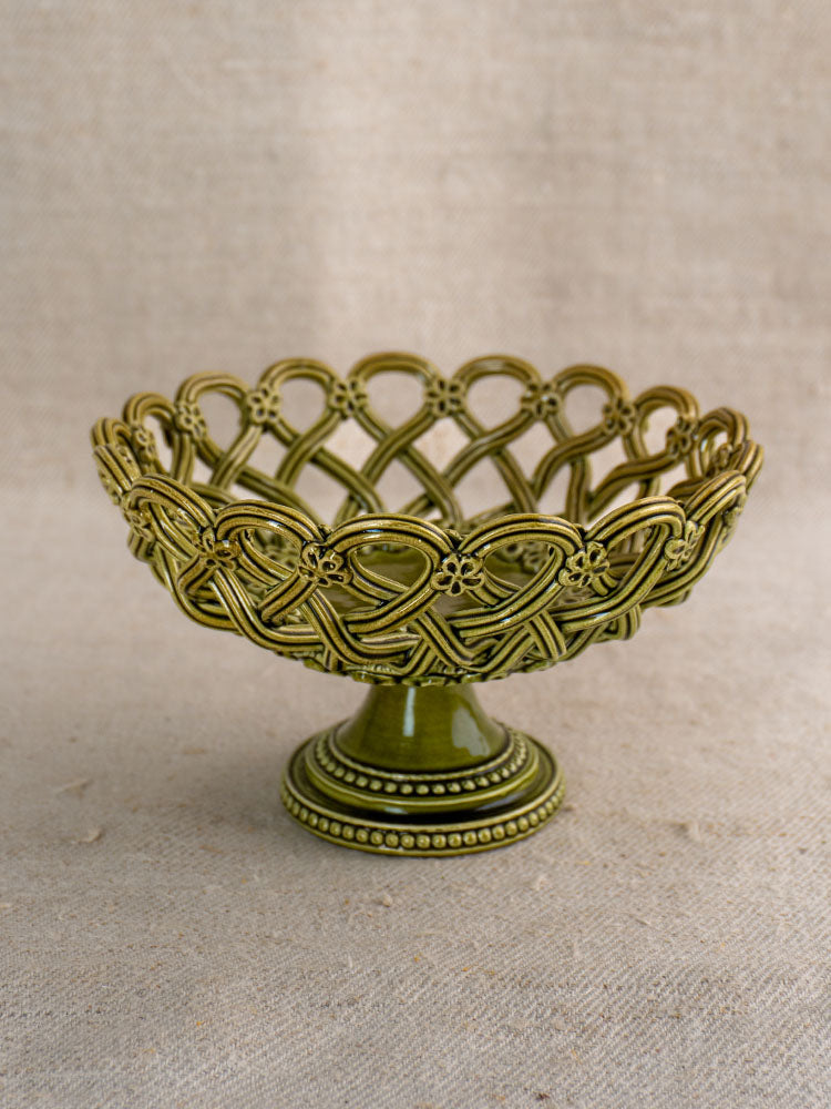 Antique French Pichon Uzès compote in olive green with openwork lattice and floral details on neutral fabric.