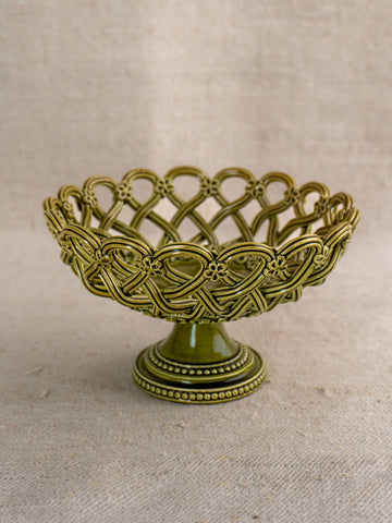 Antique French Pichon Uzès compote in olive green with openwork lattice and floral details on neutral fabric.