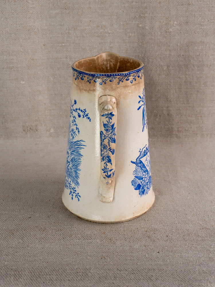 Antique French Fenal Frères Pichet with Pexonne Oiseaux blue pattern, single handle, on beige fabric.