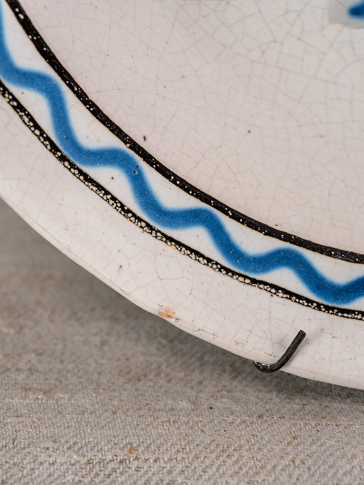 Antique French Cul Noir faience charger, late 18th c., blue wavy line, black dotted rim, Panier Fleuri motif, metal staple repair.