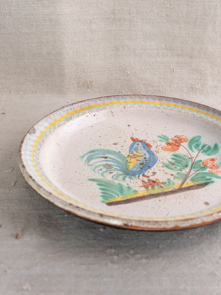 Antique French faience plate, late 19th century, hand-painted rooster with leaves and orange flowers.