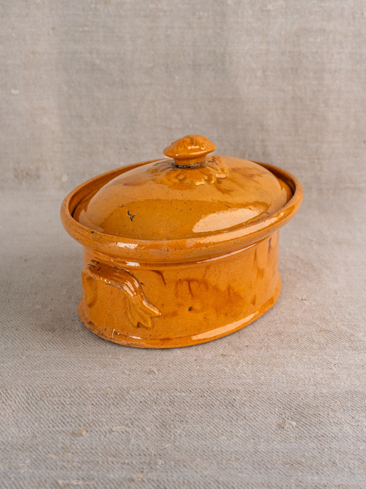 Antique French ceramic terrine, late 19th–early 20th century, mustard ochre glaze, leaf motif handle, fitted lid.