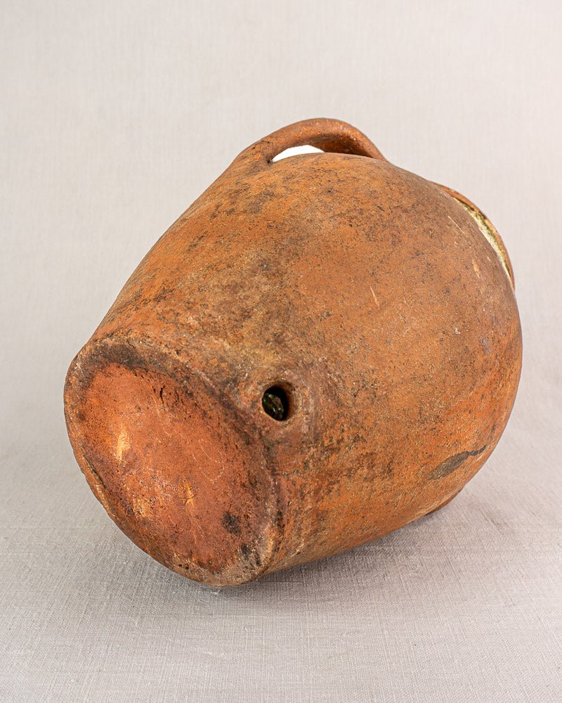Antique French glazed terracotta vinaigrier with handle, brown patina, weathered chips and spots.