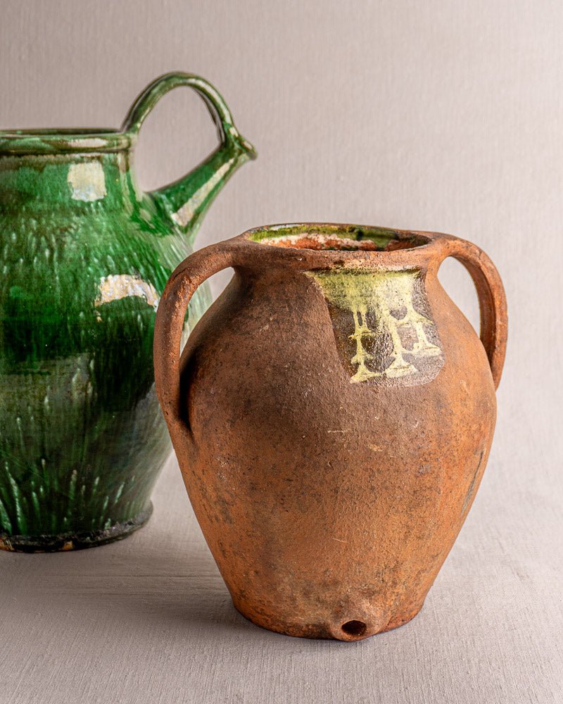 Antique French terracotta vinaigrier, circa 1880–1900, with two handles and spout on neutral surface.