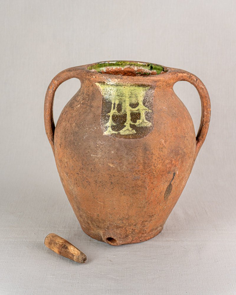 Antique French terracotta vinaigrier with two handles and spout, circa 1880–1900, on light background.