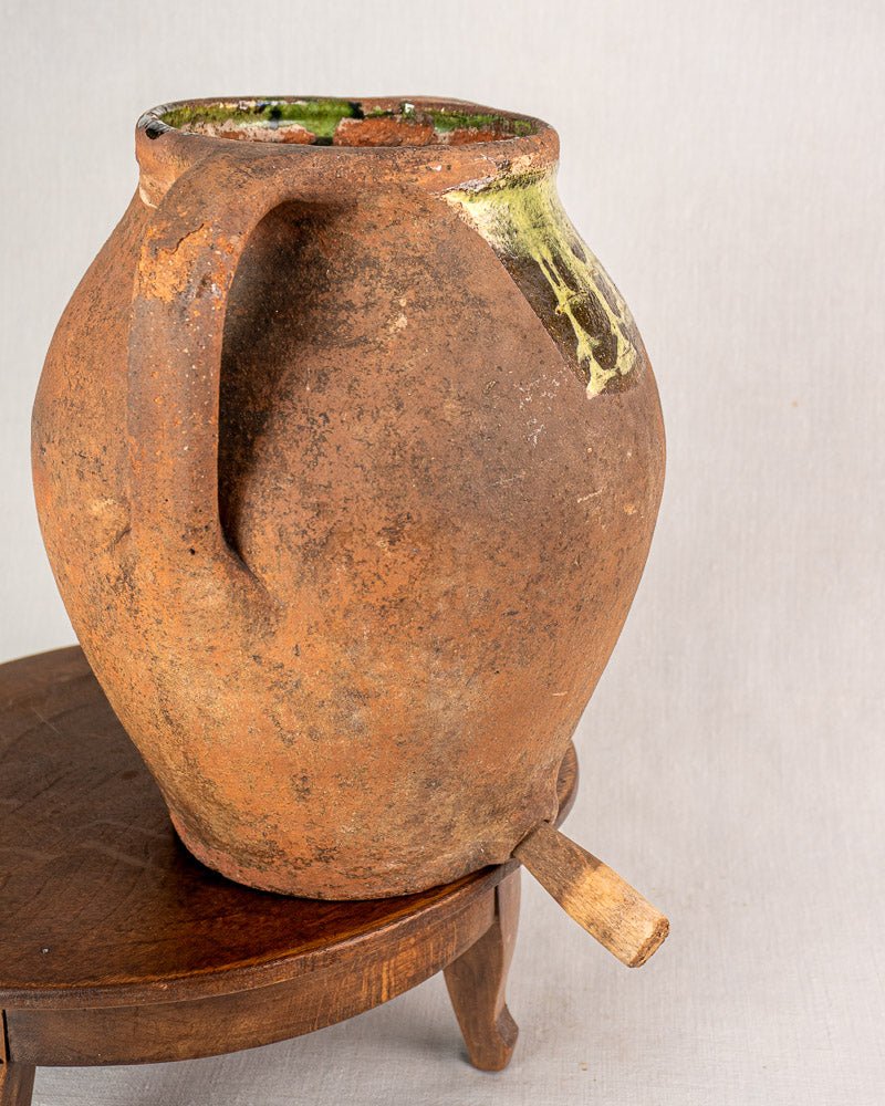 Antique French glazed terracotta vinaigrier, weathered brown body with yellow-green glaze, c. 1880–1900.