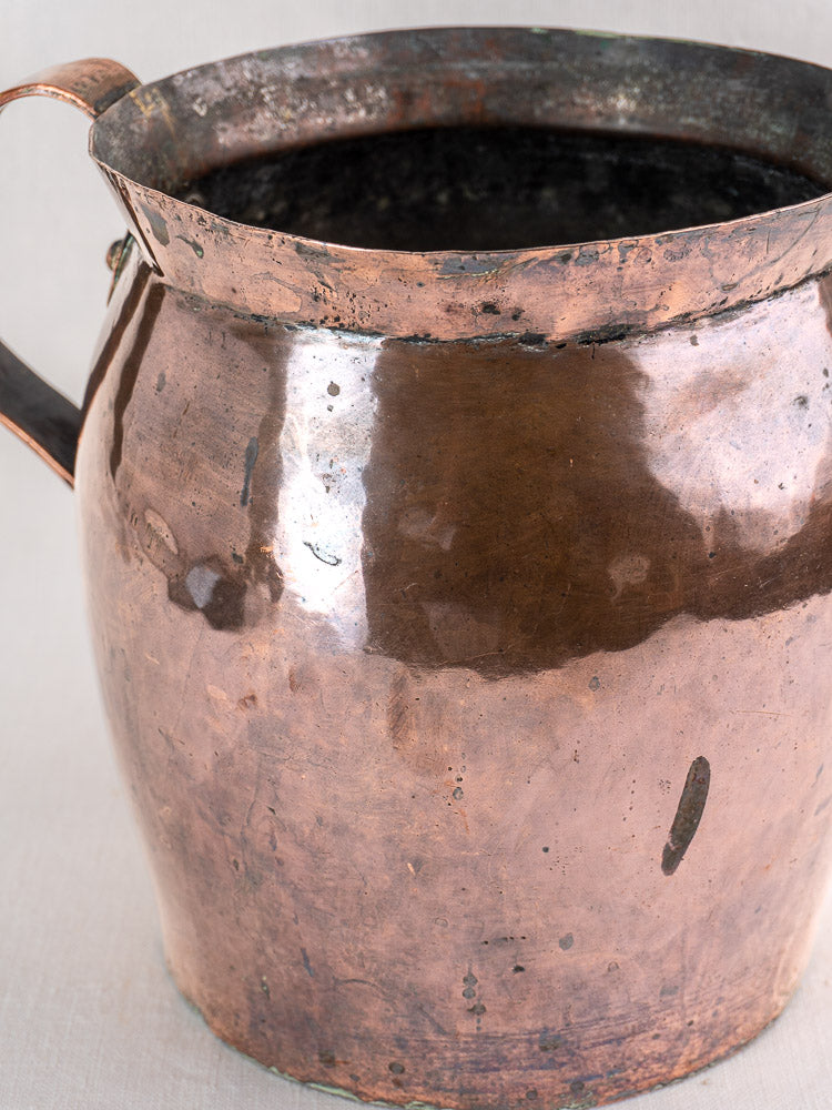 Antique French hammered copper pitcher with handle and aged patina, late 18th century, on a neutral background.