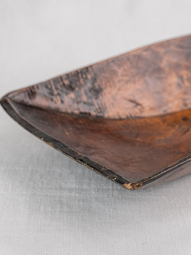 Antique French wooden grain scoop, 19th-century hand carved, dark wood with textured surface and aged patina.