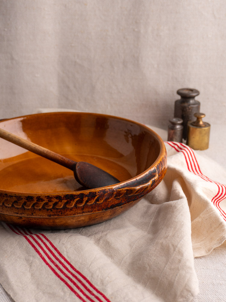 Antique French Vitry-le-François gratin dish in glazed stoneware with mixing bowl and vintage metal weights.