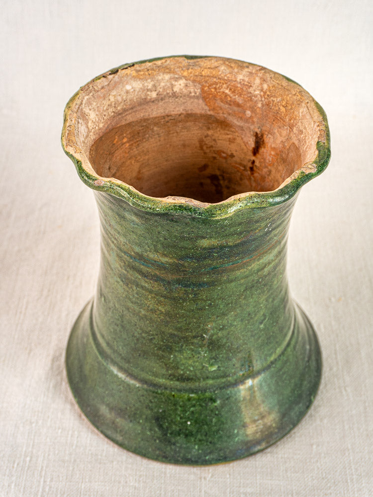 Antique French green glazed terracotta vase with scalloped rim and visible vintage wear.