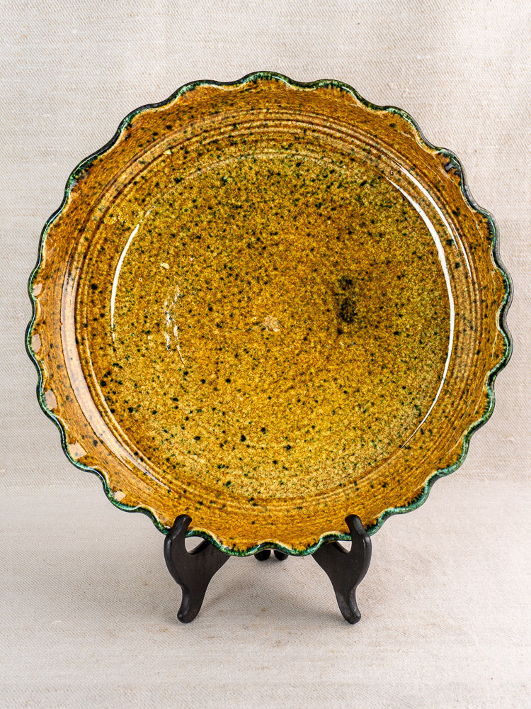 Vintage French signed JANY Studio earthenware tarte dish, wavy edge, mottled yellow glaze, green speckles.