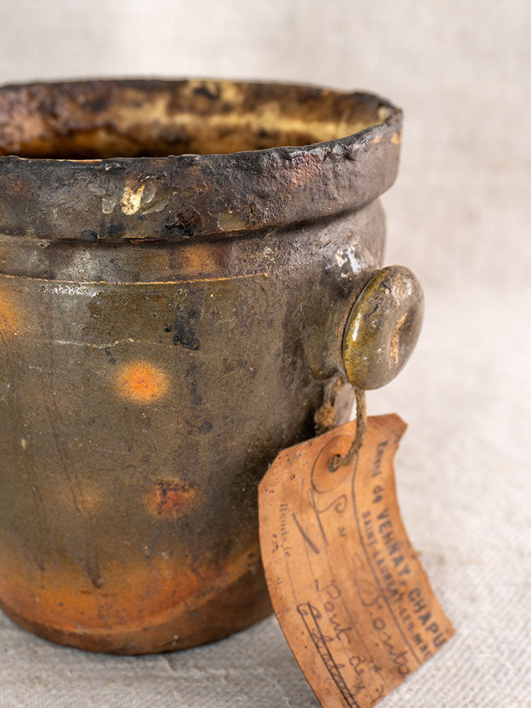 Antique French glazed terracotta pot à graisse with original merchant tag and single handle.