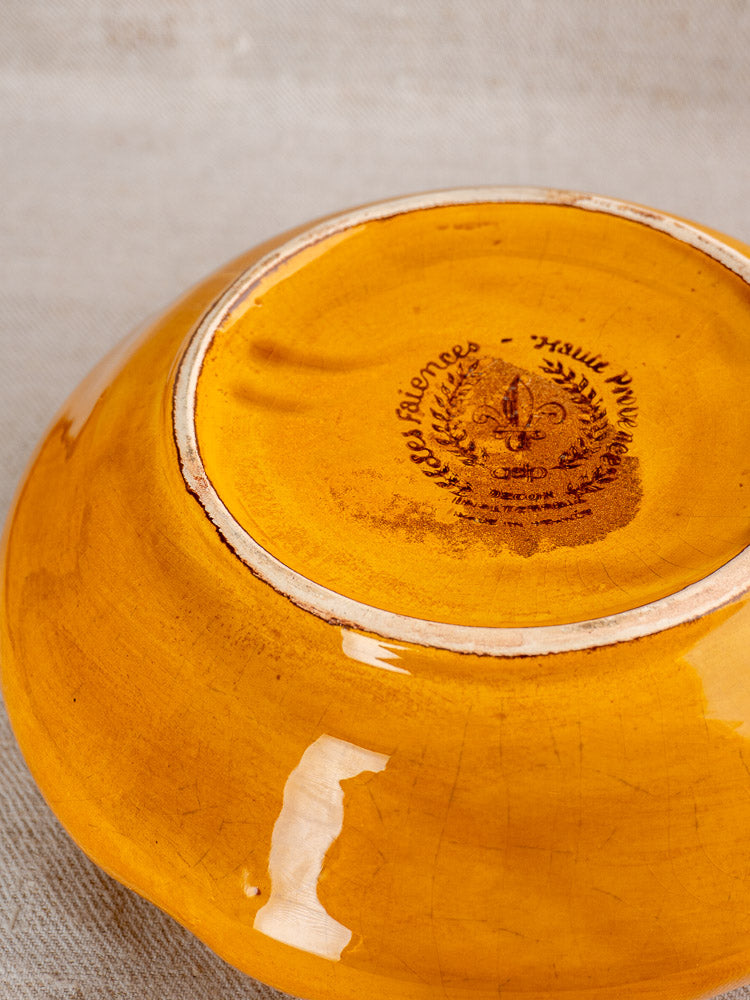 Underside of a yellow faience French Haute Provence tureen with faint maker’s mark on fabric.