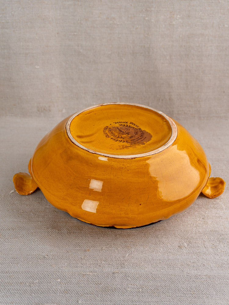 Vintage French Haute Provence faience tureen upside down, yellow glaze, pine cone finial, maker’s mark visible.