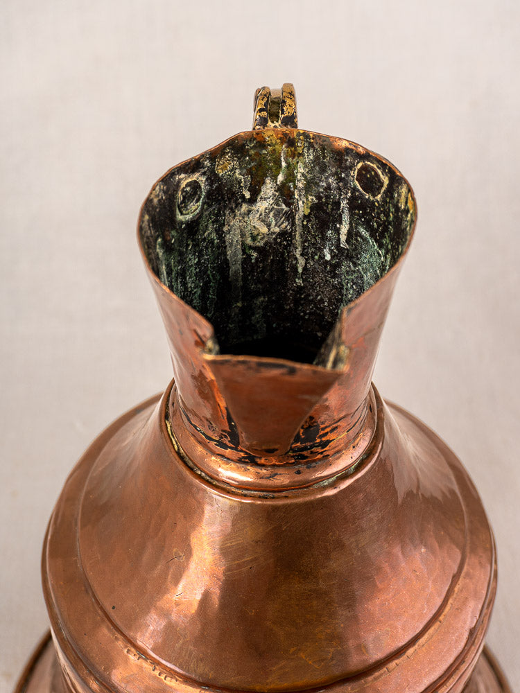 Antique French copper water jug, 19th-century broc à eau, brass handle, mouth detail with greenish patina and aging.