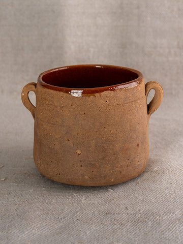 Antique French confit pot with rustic brown glaze, two handles, and glossy interior, classic 19th-century country pottery.