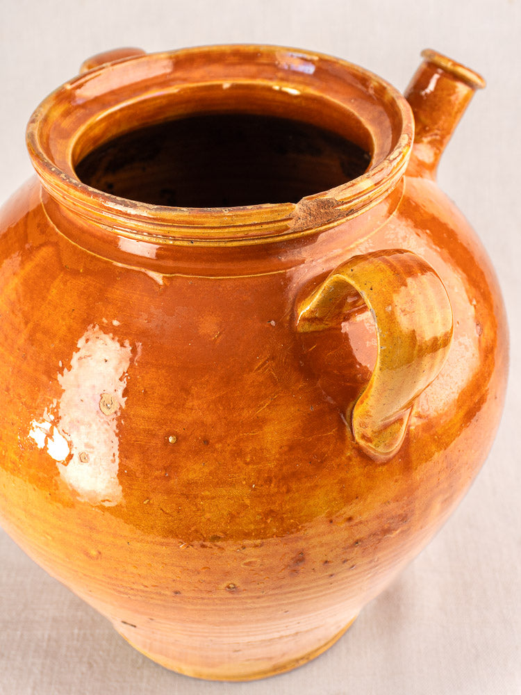 Large antique French cruche, round glazed earthenware jug with wide opening, sturdy handle, short spout, honey-brown finish.