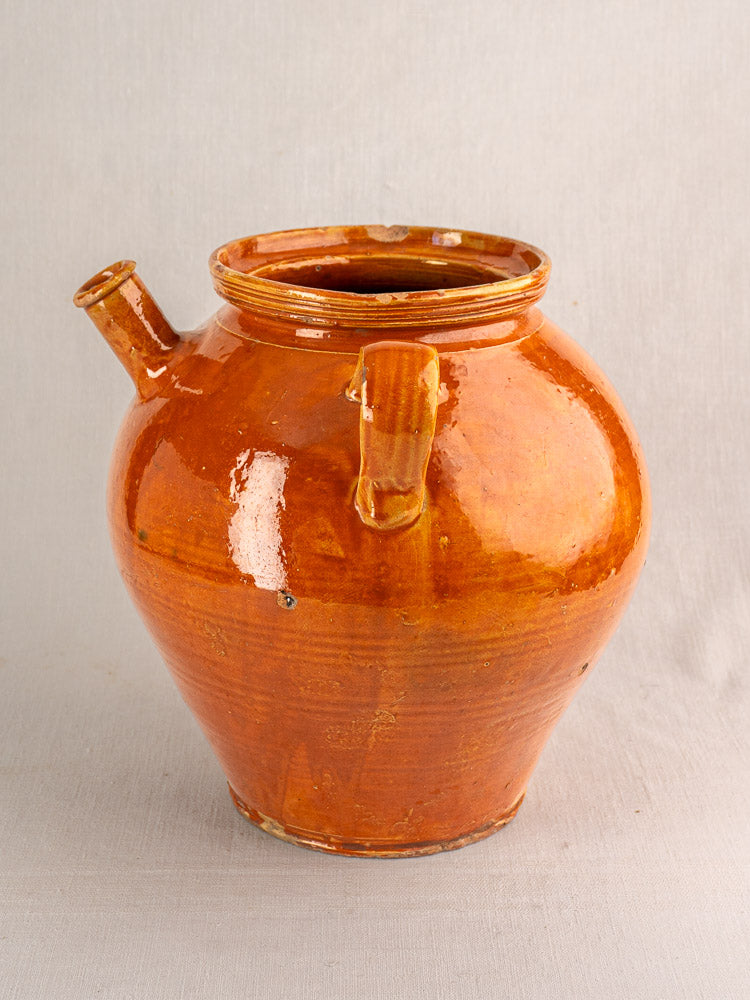 Antique French honey-brown glazed earthenware cruche with wide opening, small spout, and single handle.