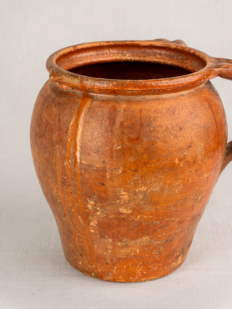 Antique French two-handle earthenware jug, 19th century, rustic brown glaze, worn texture, natural pottery imperfections.