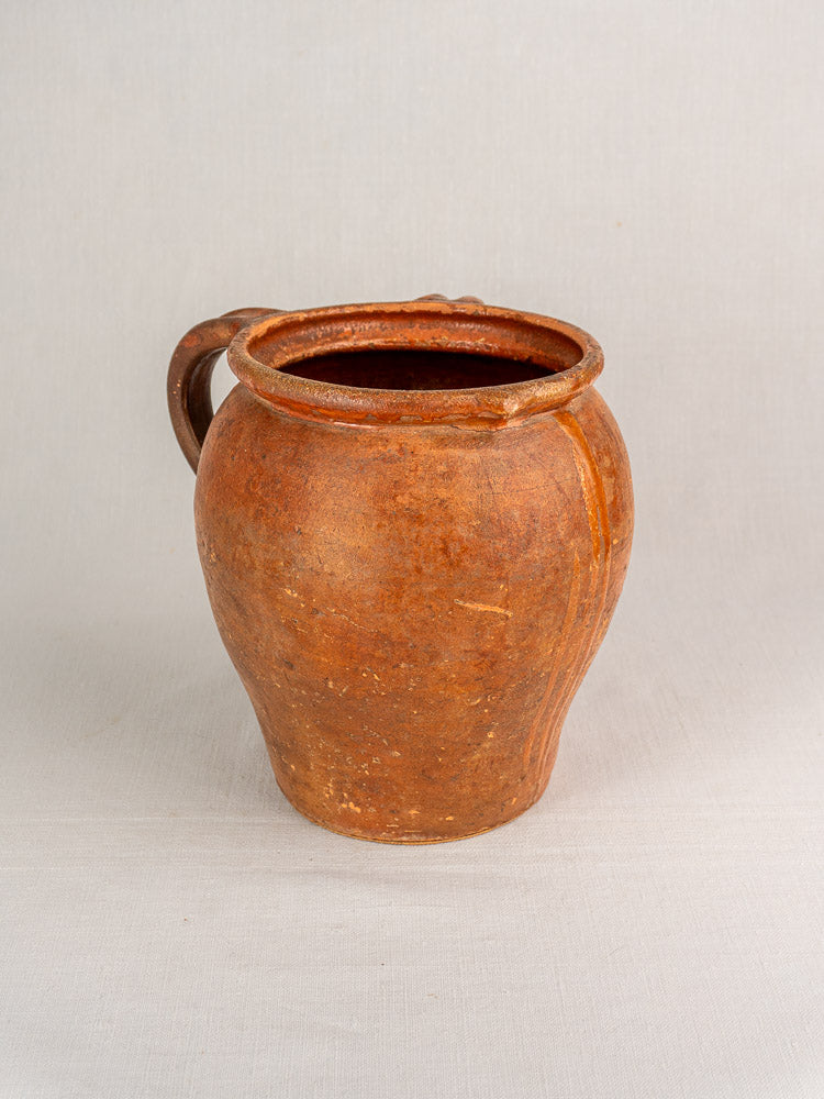 Antique French two-handle glazed earthenware jug, 19th-century Southern France, on a light background.