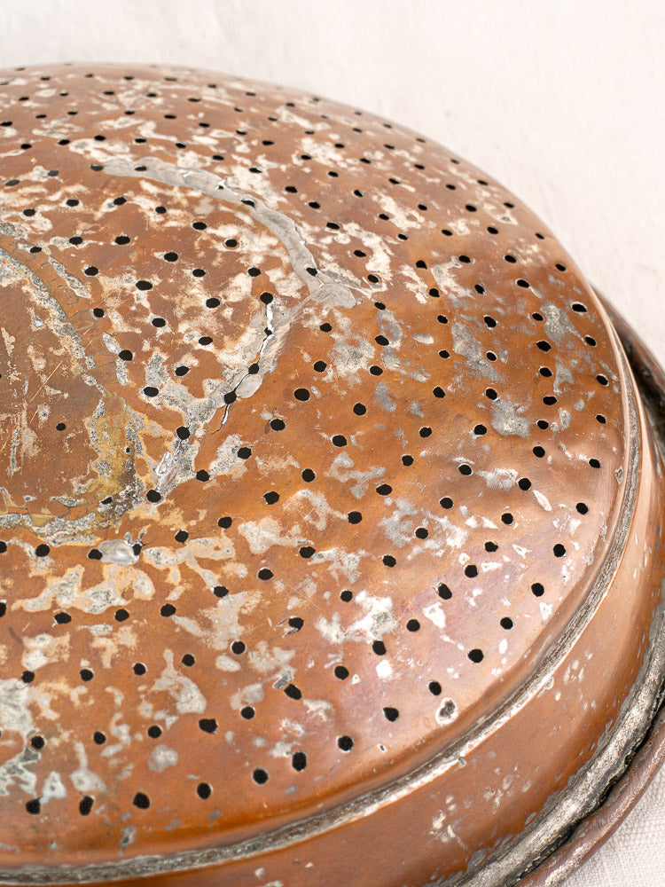 Antique French copper colander with hand-tinned finish, small perforations, and rich aged patina from the 19th century.