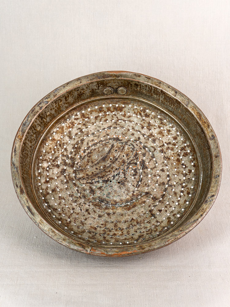 Antique French copper colander with hand-tinned finish and perforated base, shown from above on a neutral background.