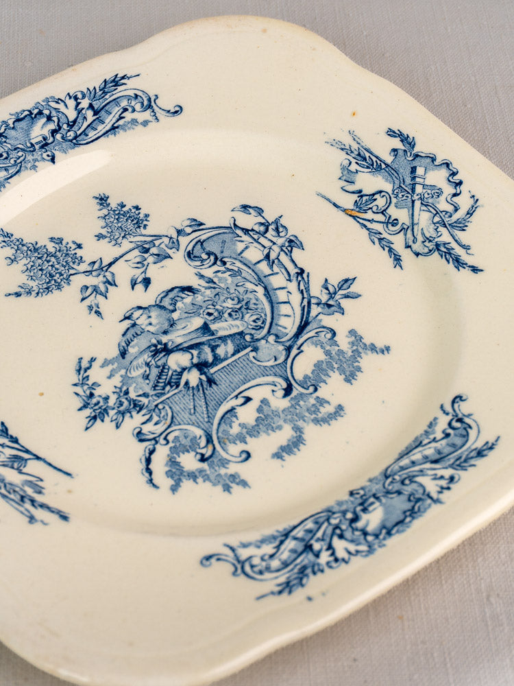 Set of 10 antique French Clairefontaine Louis XV Terre de Fer plates with blue floral and cherub motifs on light textured surface.