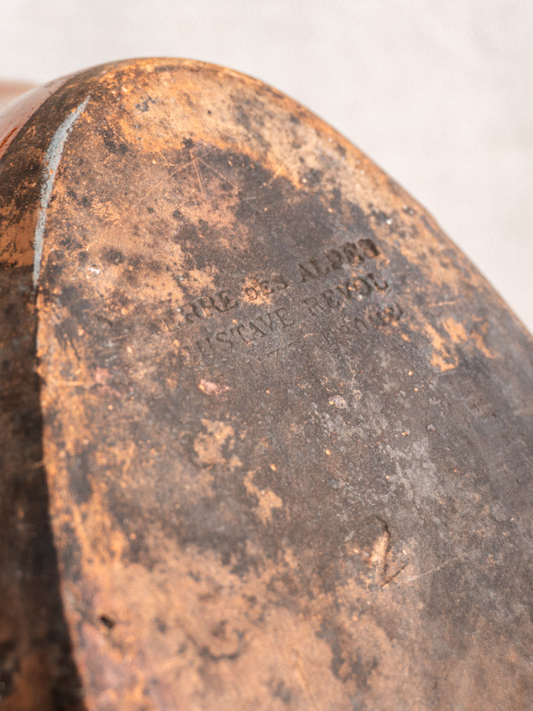 Oval brown and black antique French baking dish by Saint-Uze Revol, late 19th century, with faded engraving on terre vernissée.