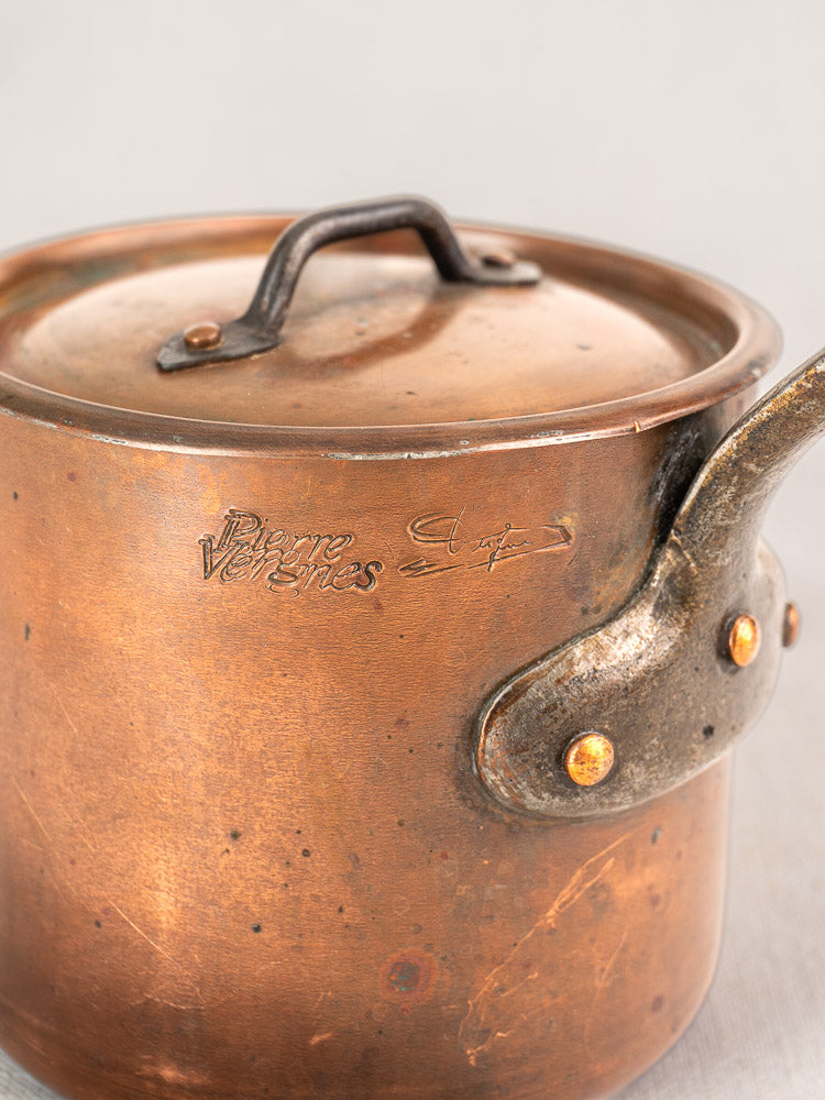 Antique French copper saucepan by Pierre Vergnes Durfort with riveted iron handle and engraved branding, showing vintage patina.