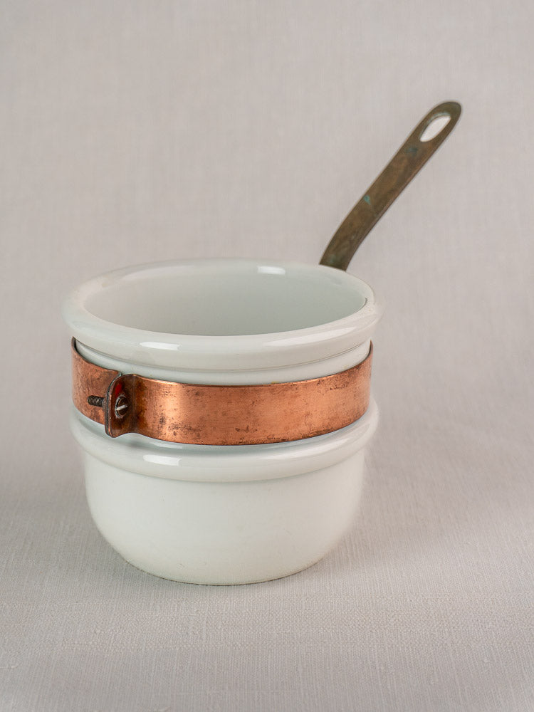 Antique French copper bain marie with Apilco porcelain insert, copper banded rim, and metal handle on a plain background.