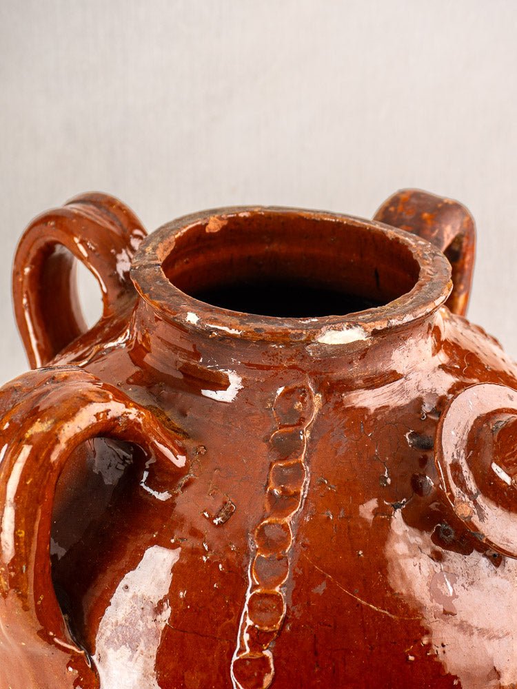 Antique French Périgord earthenware oil jug with glossy brown ceramic finish, four handles, and ridged detail.