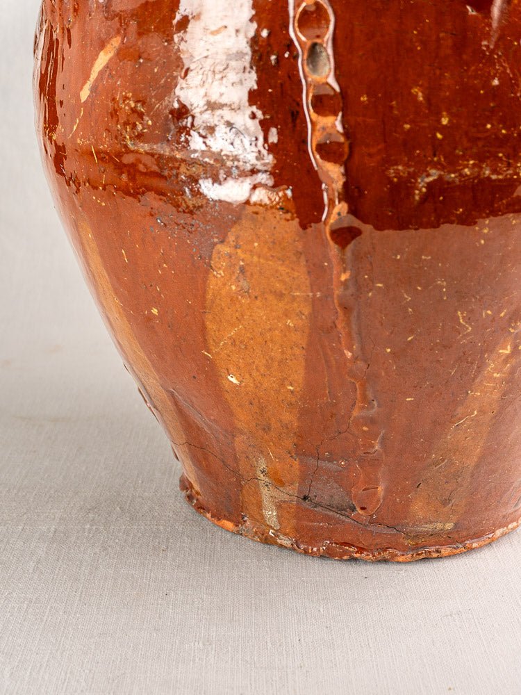Antique French earthenware walnut oil jug with rustic brown glazed ceramic surface and textured finish.