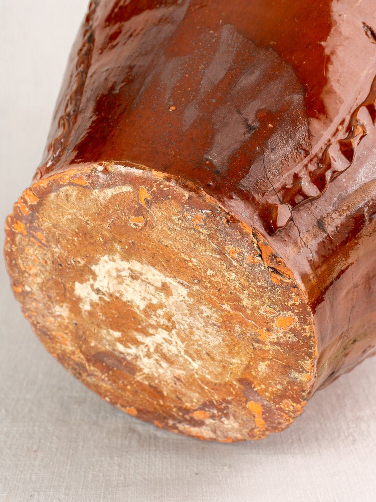Antique French 19th-century Périgord earthenware walnut oil jug with unglazed base and glossy upper body.