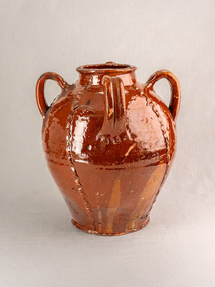 19th-century French Périgord earthenware oil jug with brown ceramic glaze, two handles, decorative ridges.