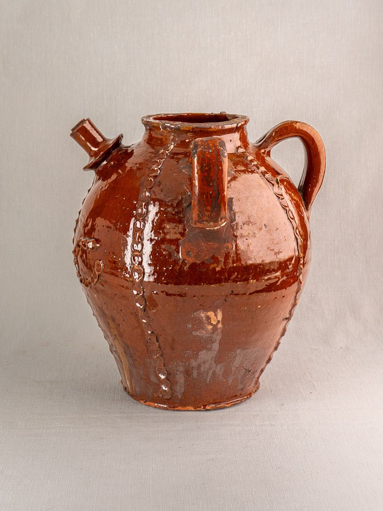 Antique French brown ceramic jug with glossy finish, handle, and short spout; Périgord earthenware.