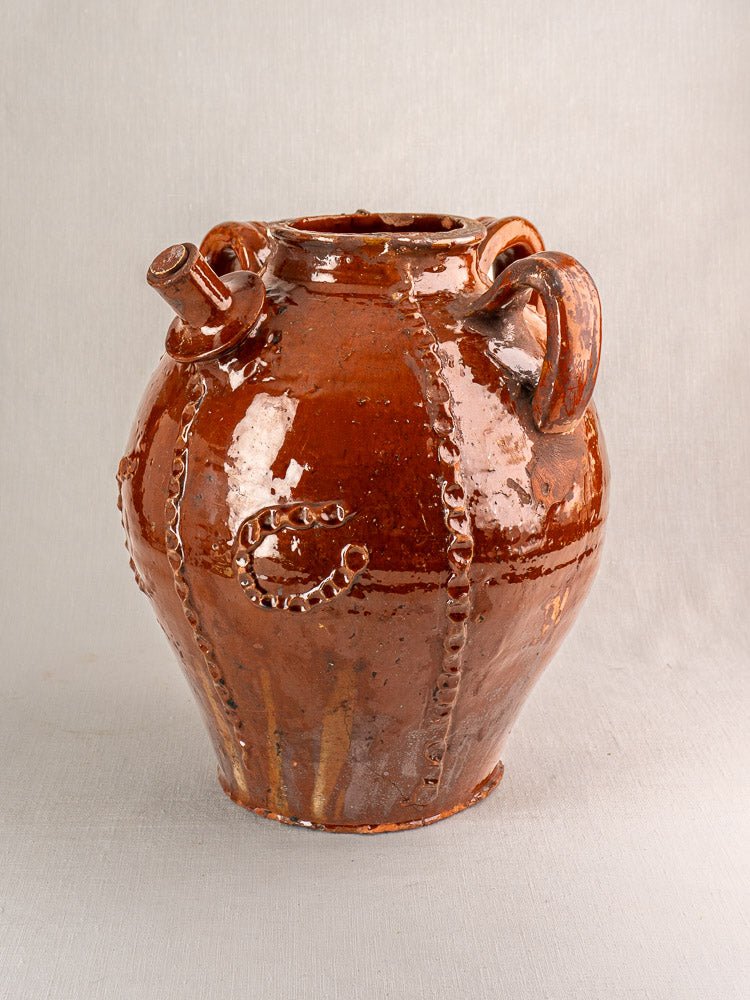 Antique French Périgord earthenware oil jug with glossy brown ceramic finish, two handles, and decorative ridges.