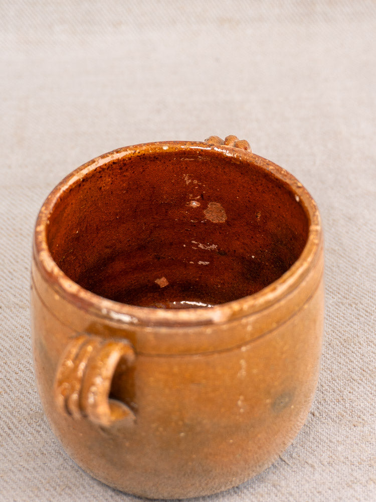 Set of three antique French Vallauris glazed terracotta pots with warm brown finish and petite handles.