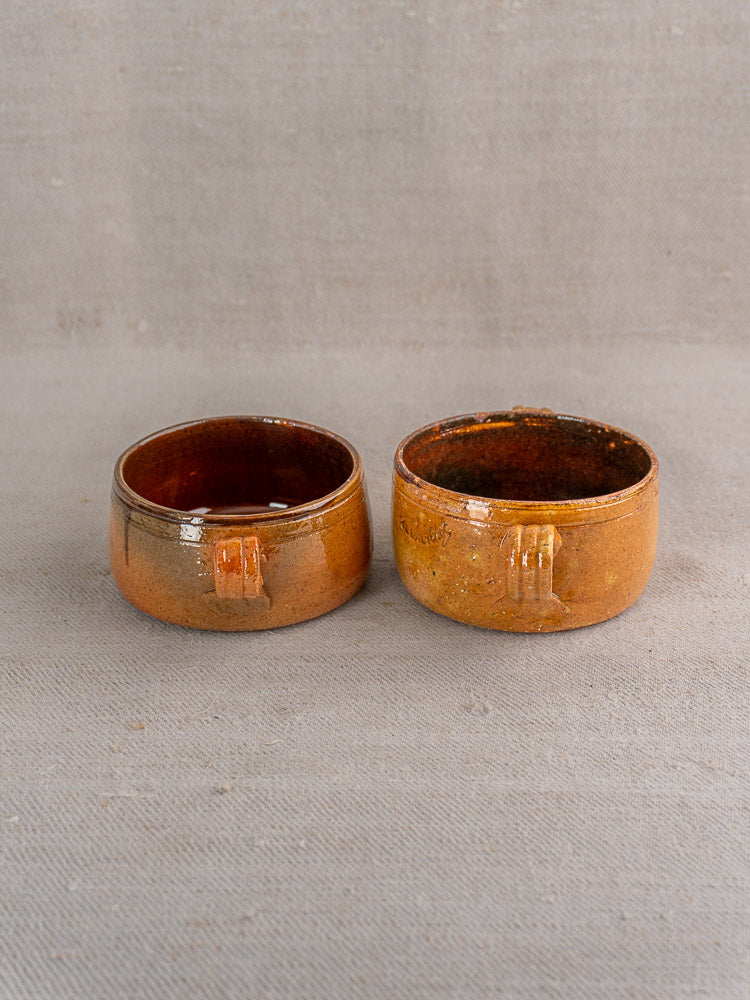 Set of three antique French Vallauris pots in glossy brown glazed terracotta with rectangular side accents.