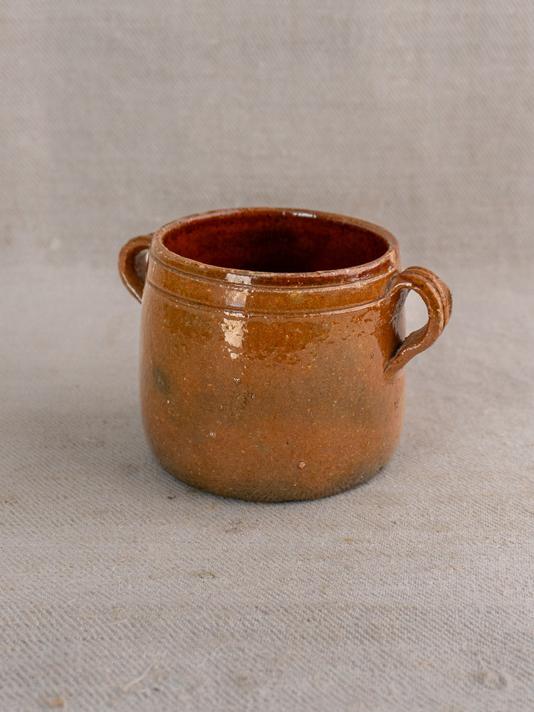 Set of three small brown glazed French terracotta pots with side handles and vintage accents.