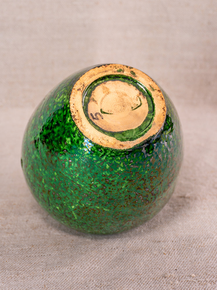 Antique French Vallauris chaufferette upside down, green glaze, textured body, circular unglazed base with edge markings on fabric.