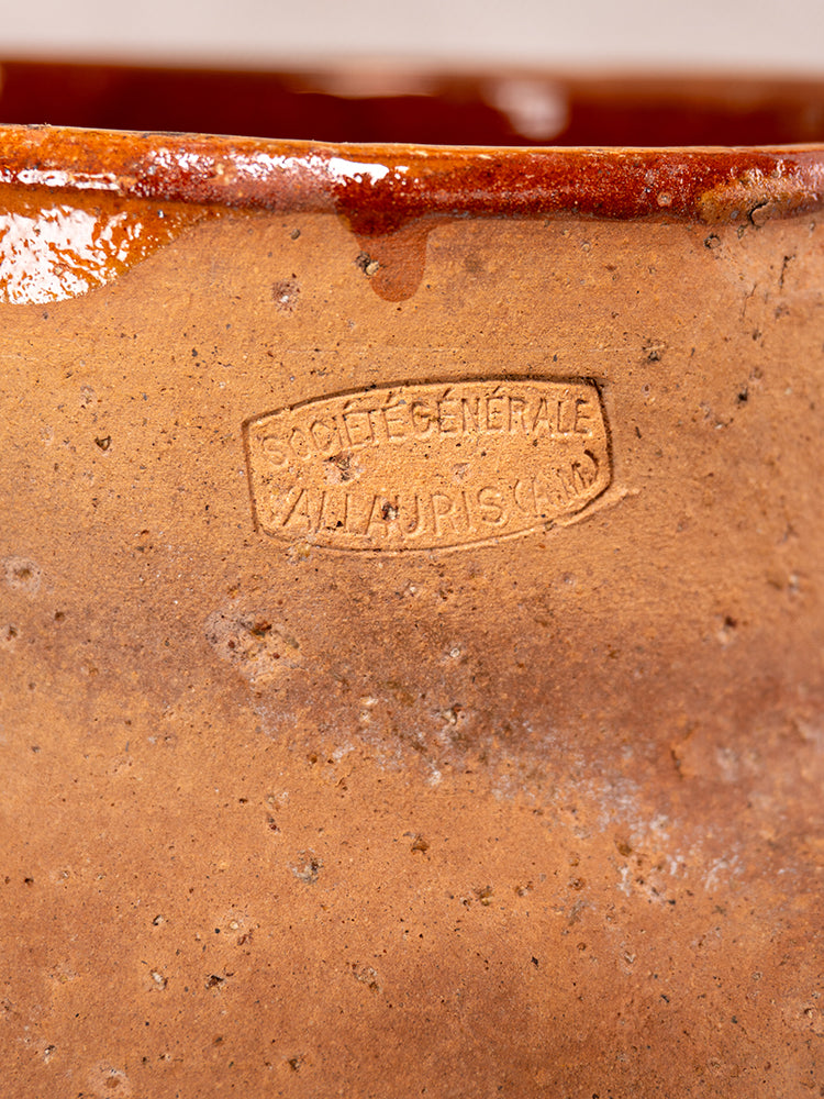 Vallauris glazed terracotta pot à lait with Societe Generale mark, glossy rim, reddish-brown glaze drips, Provençal pottery style.