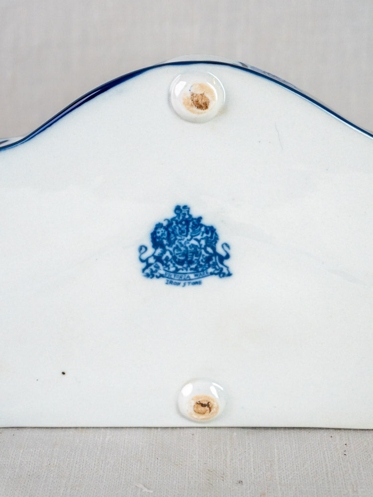 Blue and white ironstone inkstand base with three circular feet and crest maker’s mark.
