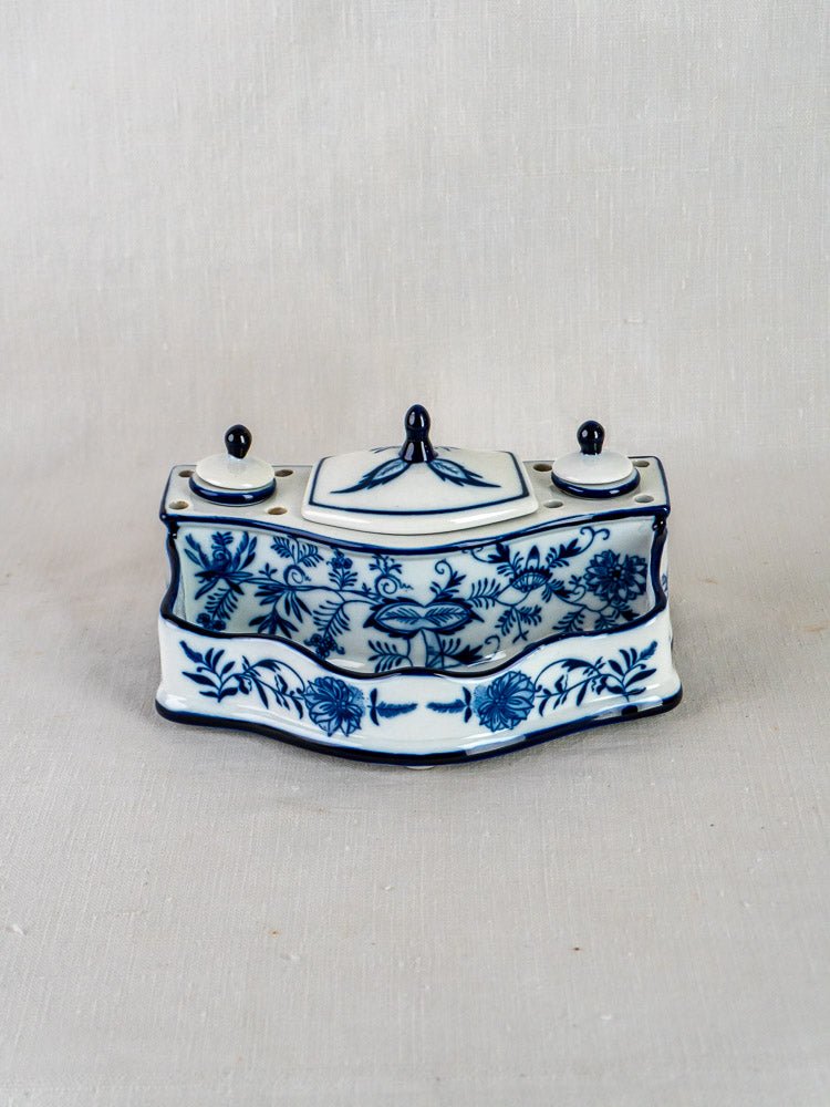 Blue and white ironstone inkstand with Blue Onion floral motif, two lidded containers, light background.