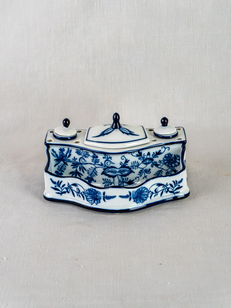 Blue and white ironstone inkstand with Blue Onion floral motif, two lidded containers, light background.