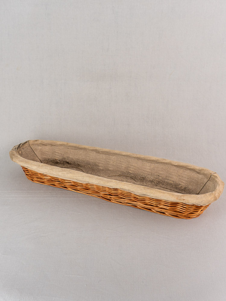 Vintage French baguette proofing baskets from 1940–1950 with linen liners, designed for baking classic long loaves.