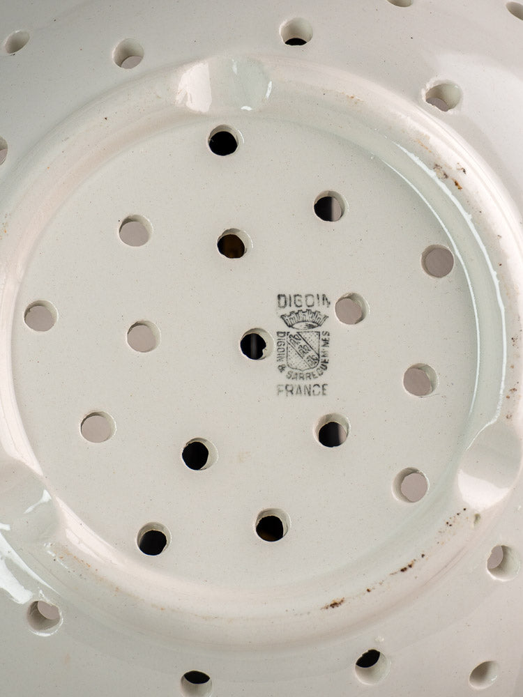 Antique French stoneware berry strainer by Digoin Sarreguemines with drainage holes and black maker’s mark at center.