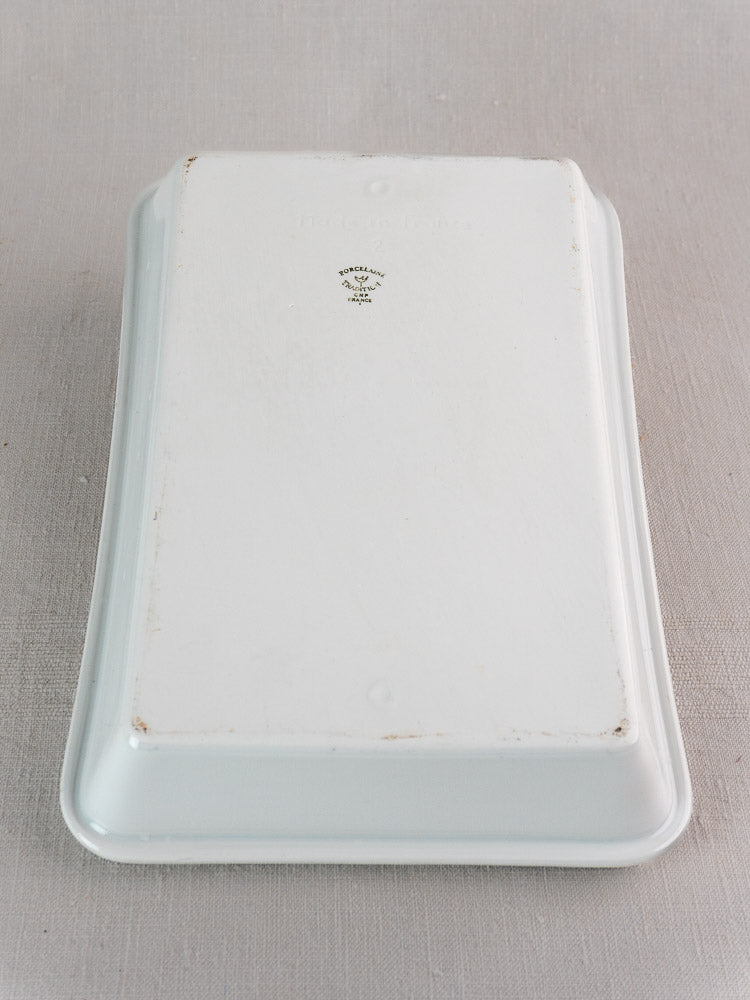 Vintage French porcelain baking dish, white rectangular, upside down showing Porcelaine Tradition CNP mark on fabric.