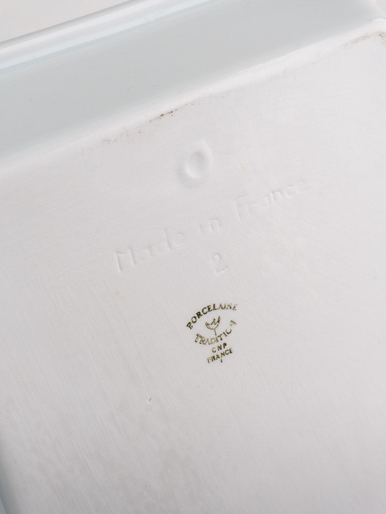 Bottom of vintage French porcelain baking dish with embossed "Made in France," number 2, maker’s mark.