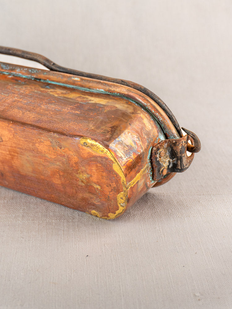 Antique French copper poissonnière fish kettle, 19th century, with yellow-green patina, rounded edges, and dark metal handle.