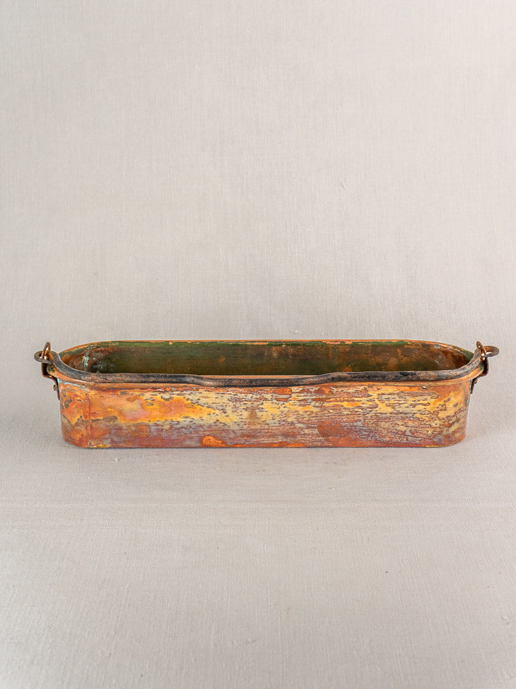 19th-century French copper fish kettle, rectangular with rounded corners and side handles, on a plain light gray background.